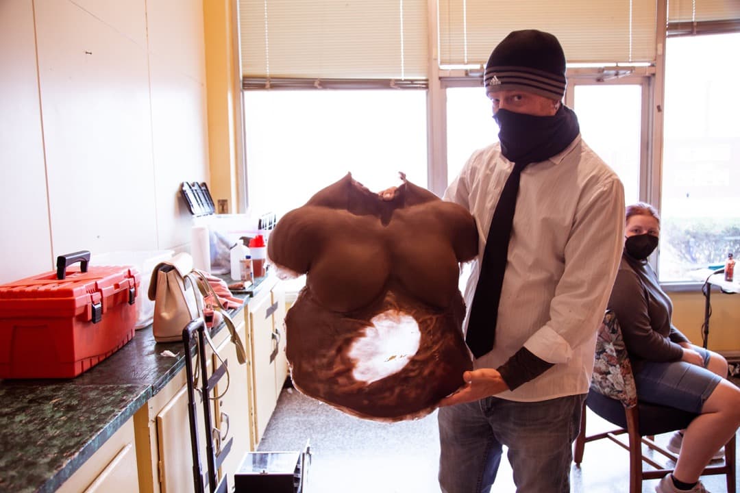 Behind the scenes photo 50 from Clone Cops production showing special effects artist rick prince shows off a practical effect